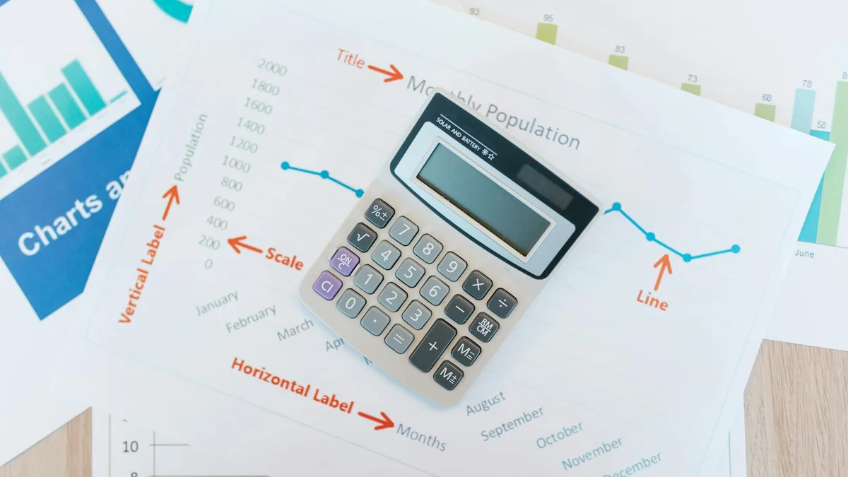 A calculator and notes on a desk, weighing the cost and payback of automation