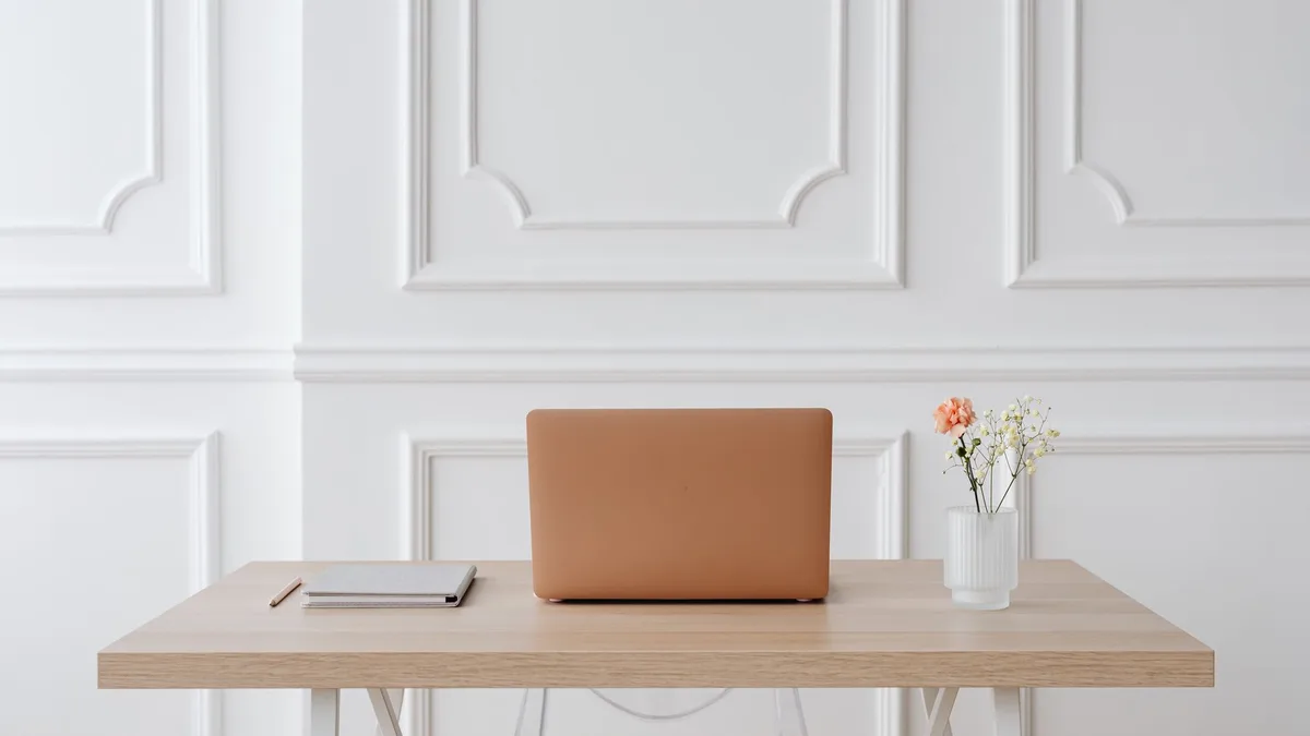 Empty modern office desk with a single notebook, automation not needed