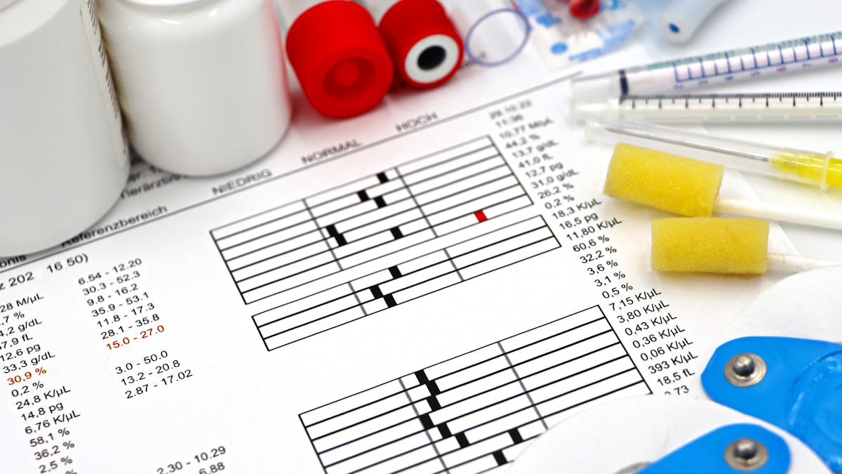 Lab tests and patient health data arranged on a clinical desk