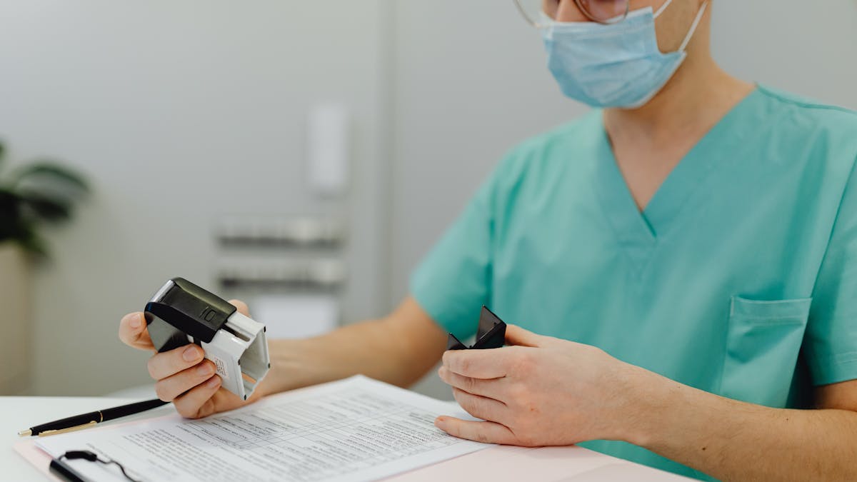 A healthcare worker reviewing patient files by hand