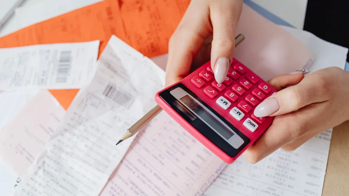 Invoice documents and a calculator on a desk