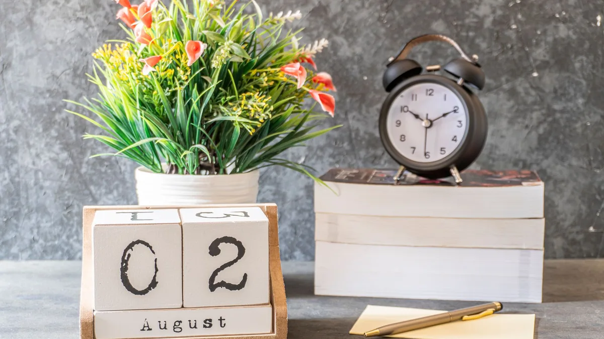 Calendar and clock on a clean desk for scheduling